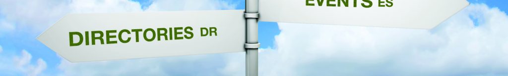 Signpost in blue sky with fluffy white clouds